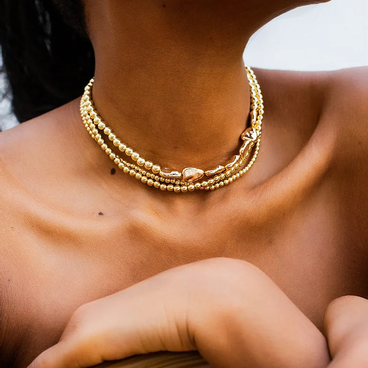 Ladies with vintage pearls stacked with woven Baroque ornaments
