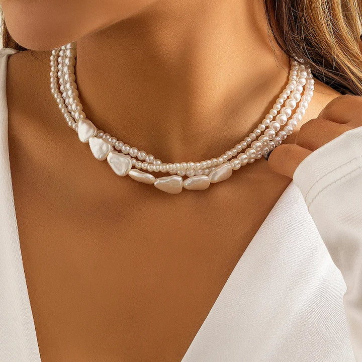 Ladies with vintage pearls stacked with woven Baroque ornaments